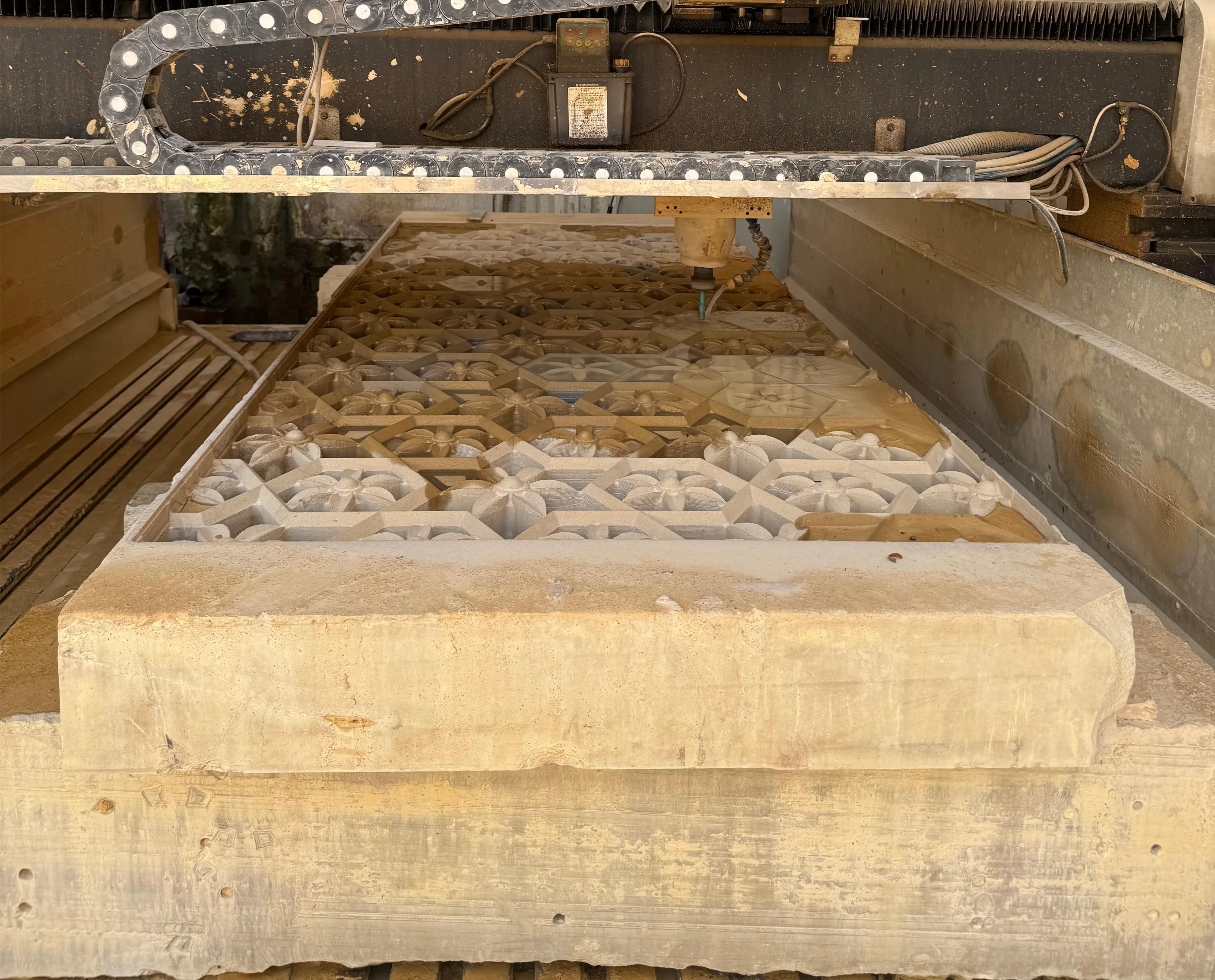 CNC machine bed with a freshly carved stone panel