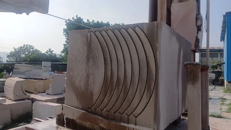 Stone block cut into curved slices by wire saw