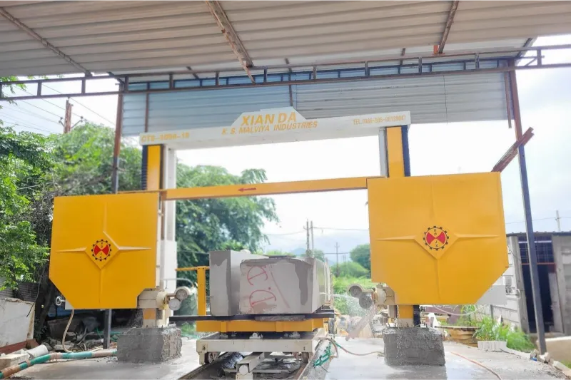 CNC wire saw gantry cutting a stone block