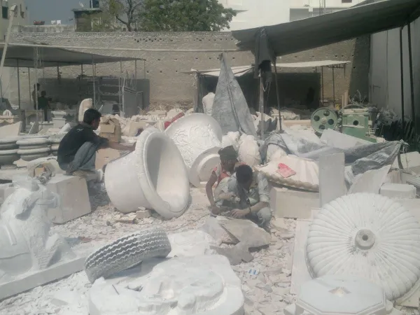 Artisans shaping marble pieces at the Umang Arts workshop