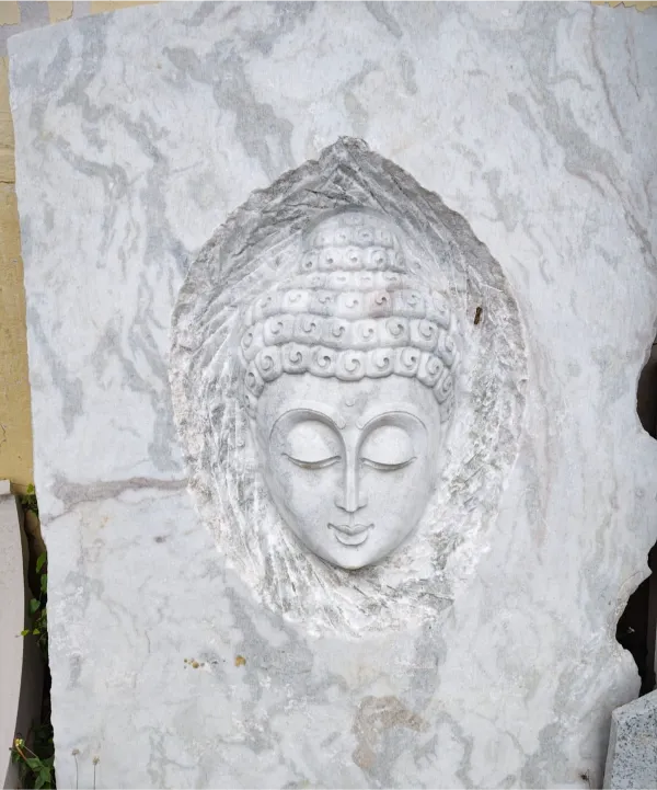 Buddha face carved in white marble