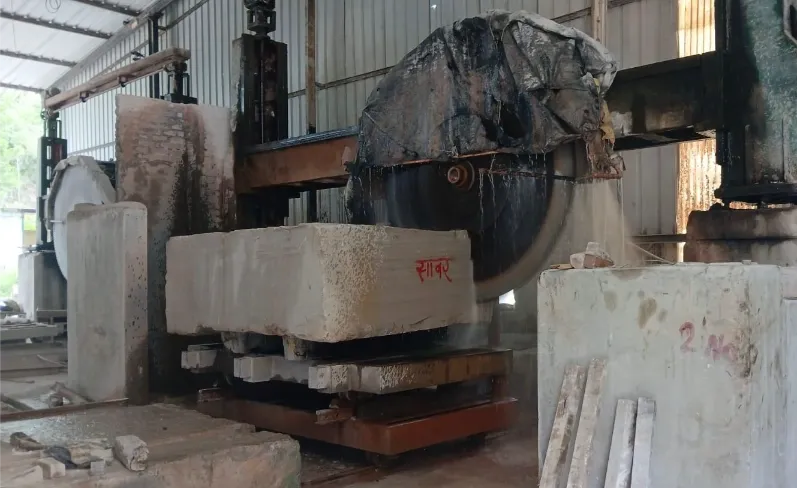 Large block cutter sawing a raw stone block