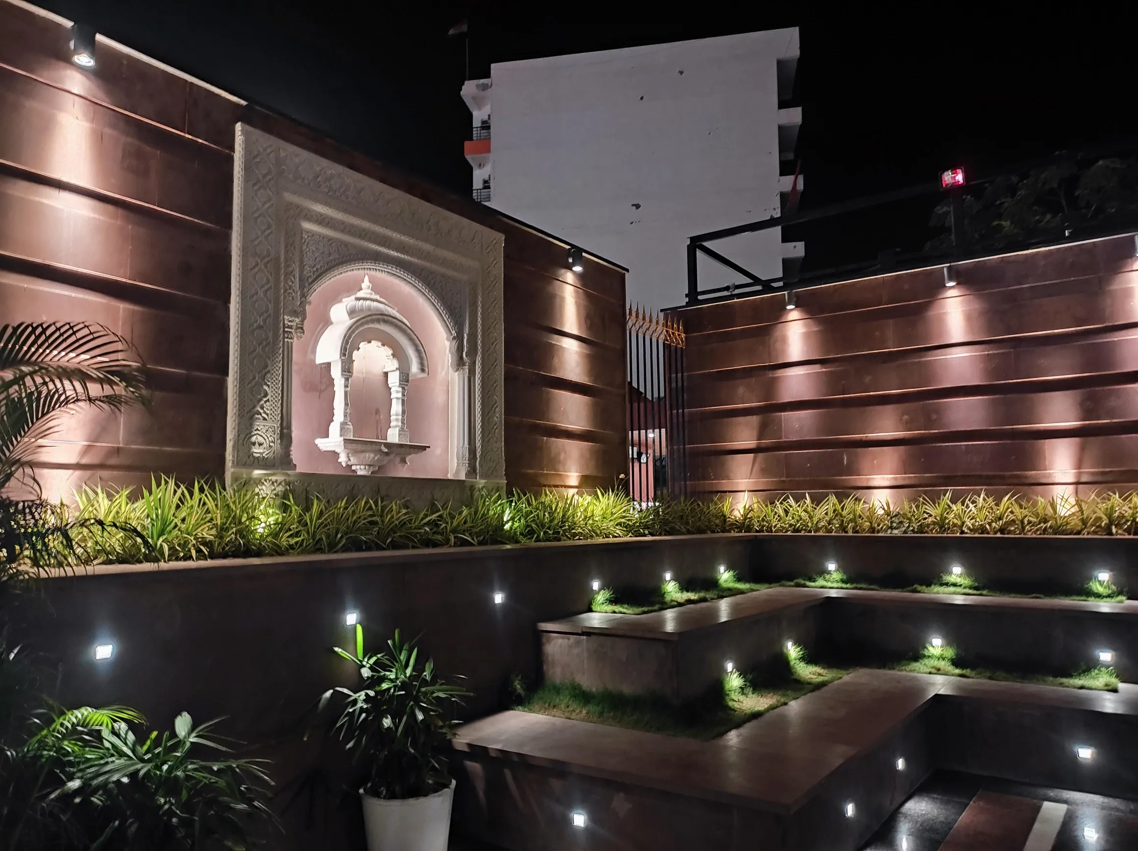 Carved stone jharokha lit at night