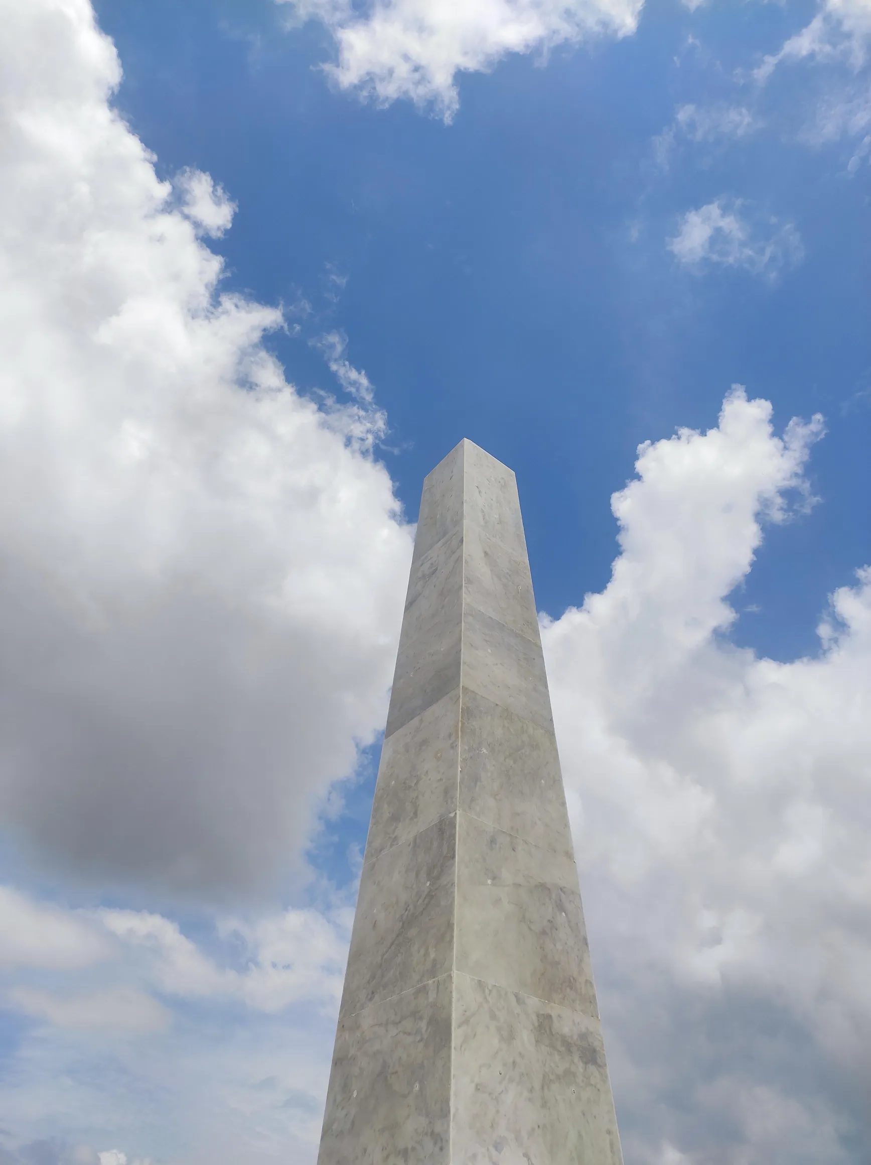 Stone obelisk against a blue sky