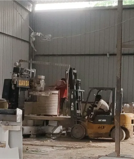 Round stone column being turned on a CNC lathe in the workshop