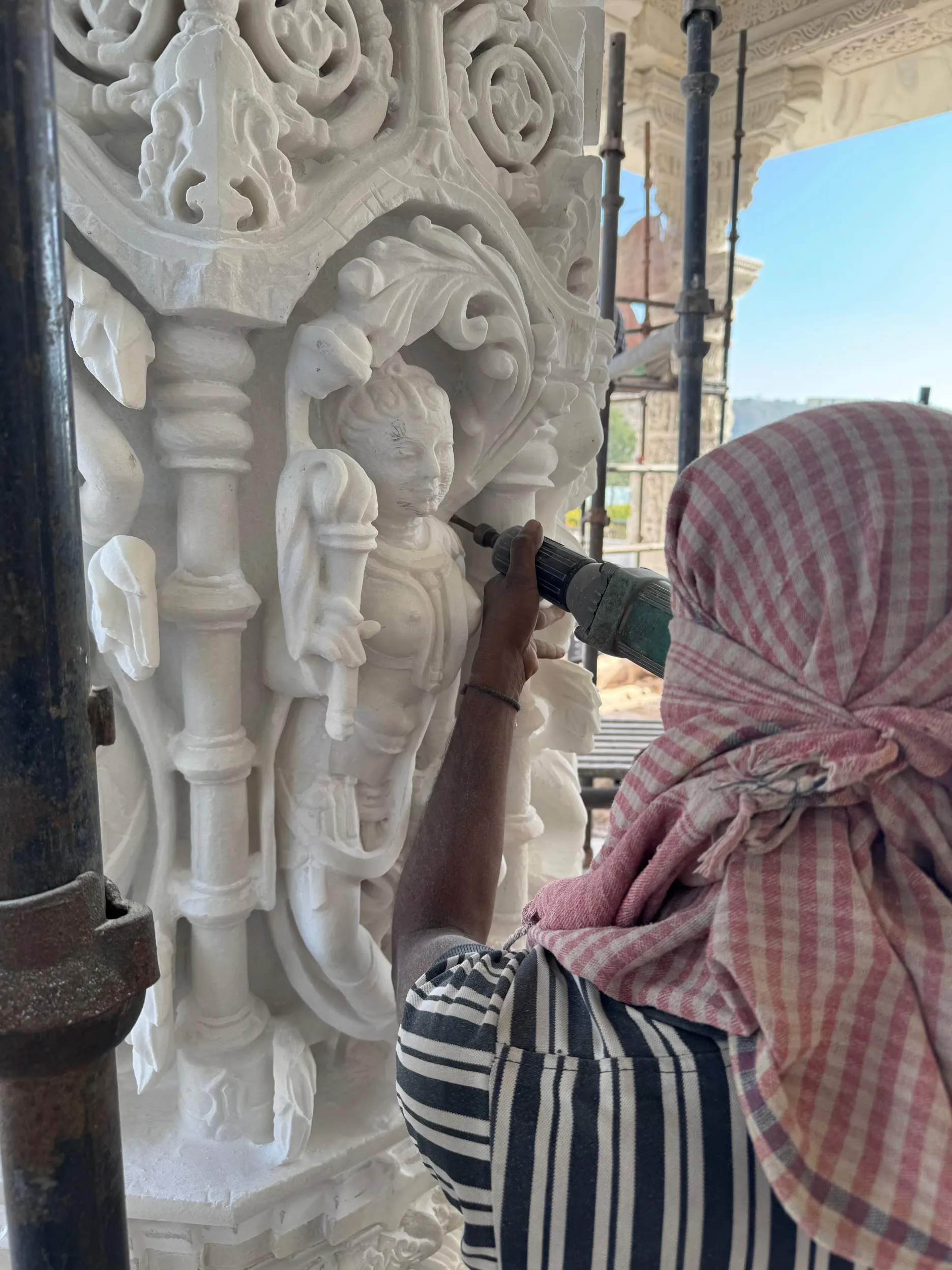 Artisans hand-carving a custom marble inlay panel