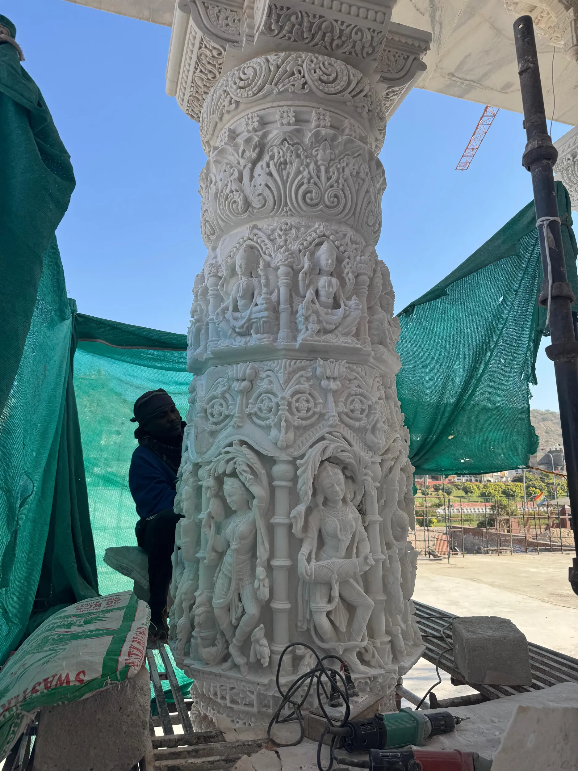Artisans carving temple pillar components