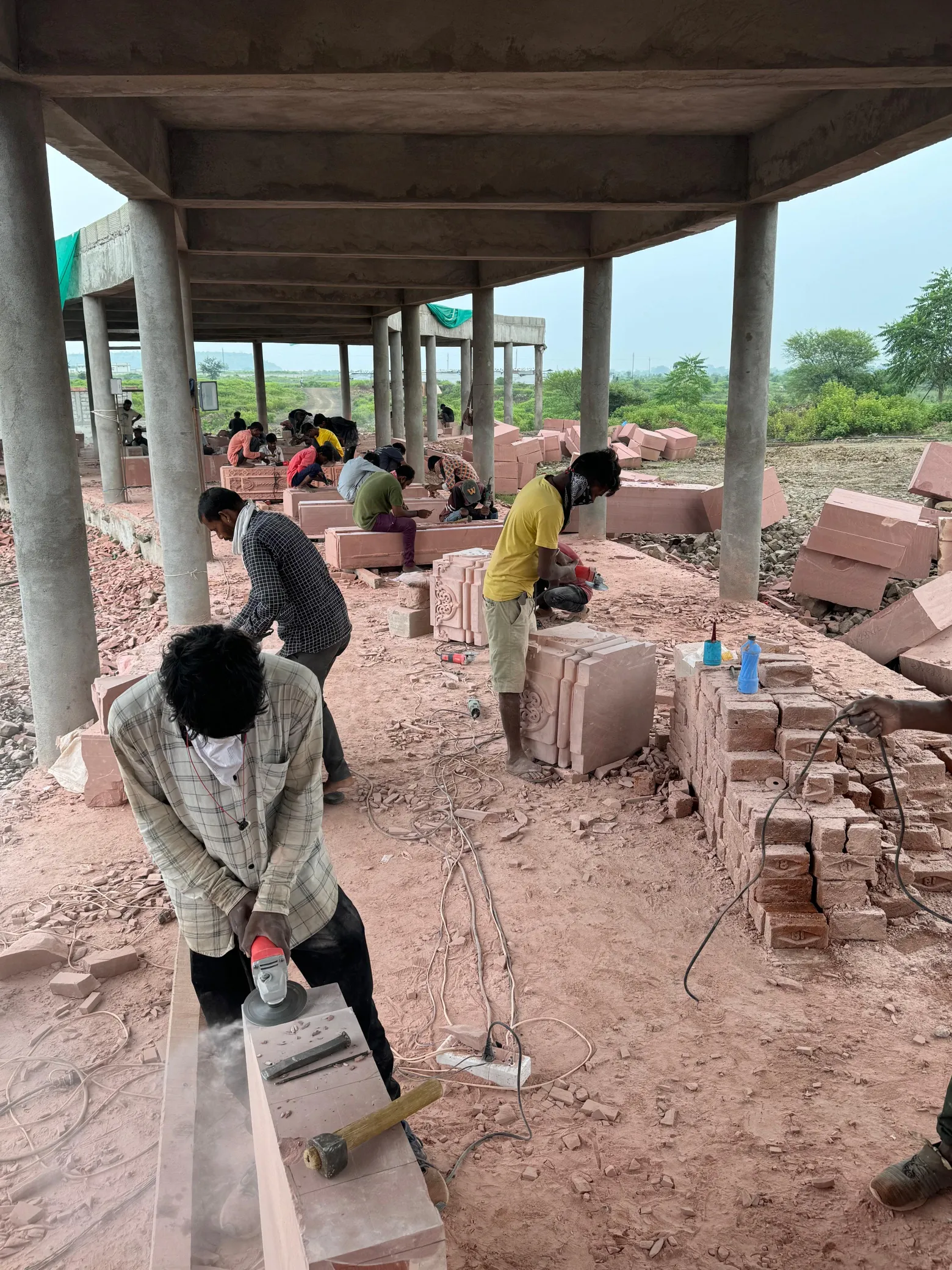 Artisans carving temple pillar components