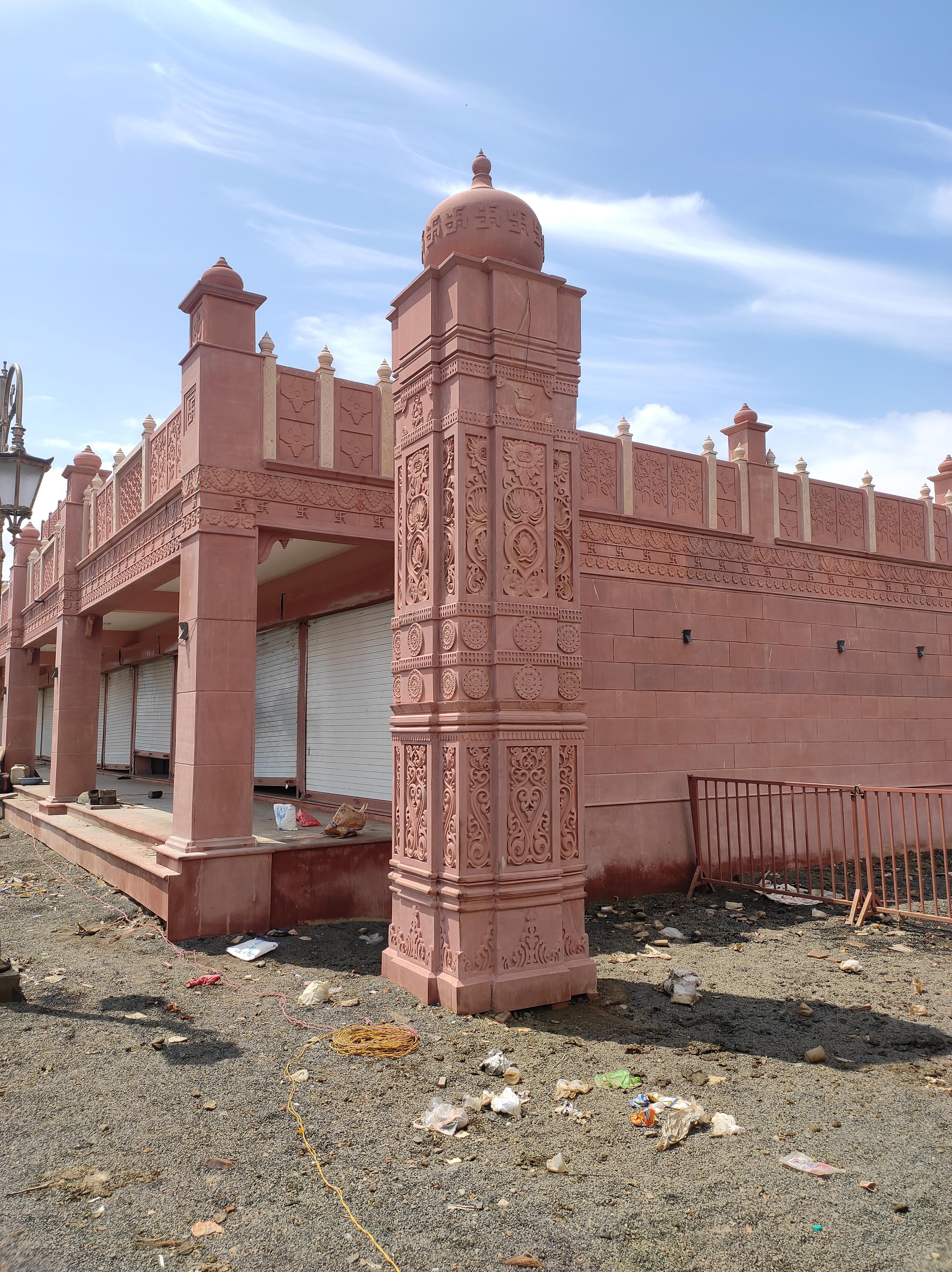 Carved red sandstone pillar with a domed top