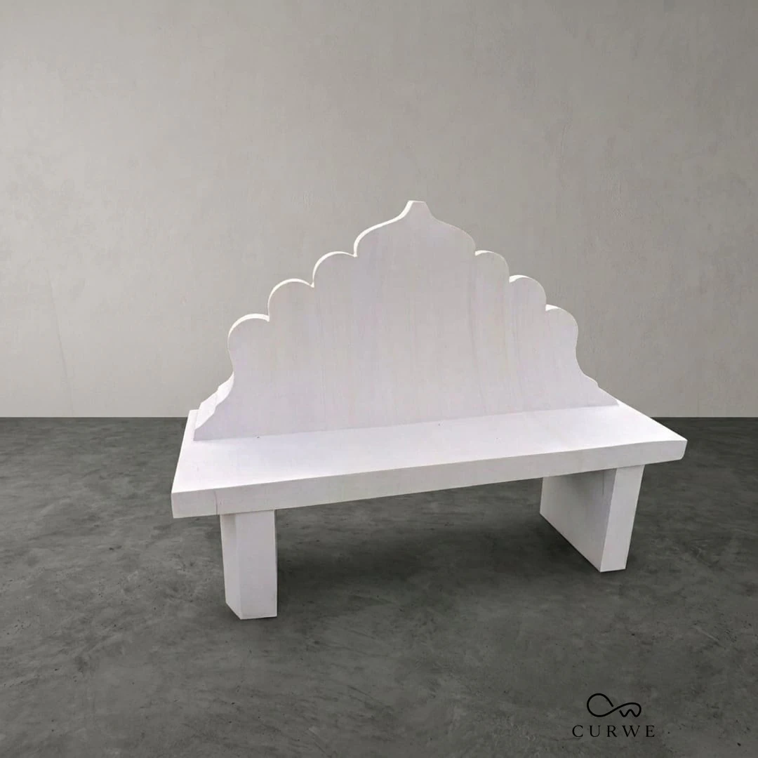 White marble bench with a carved scalloped backrest