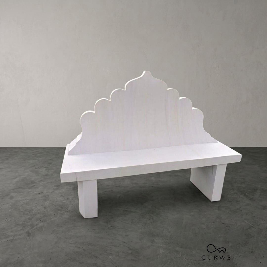 White marble bench with a carved scalloped backrest