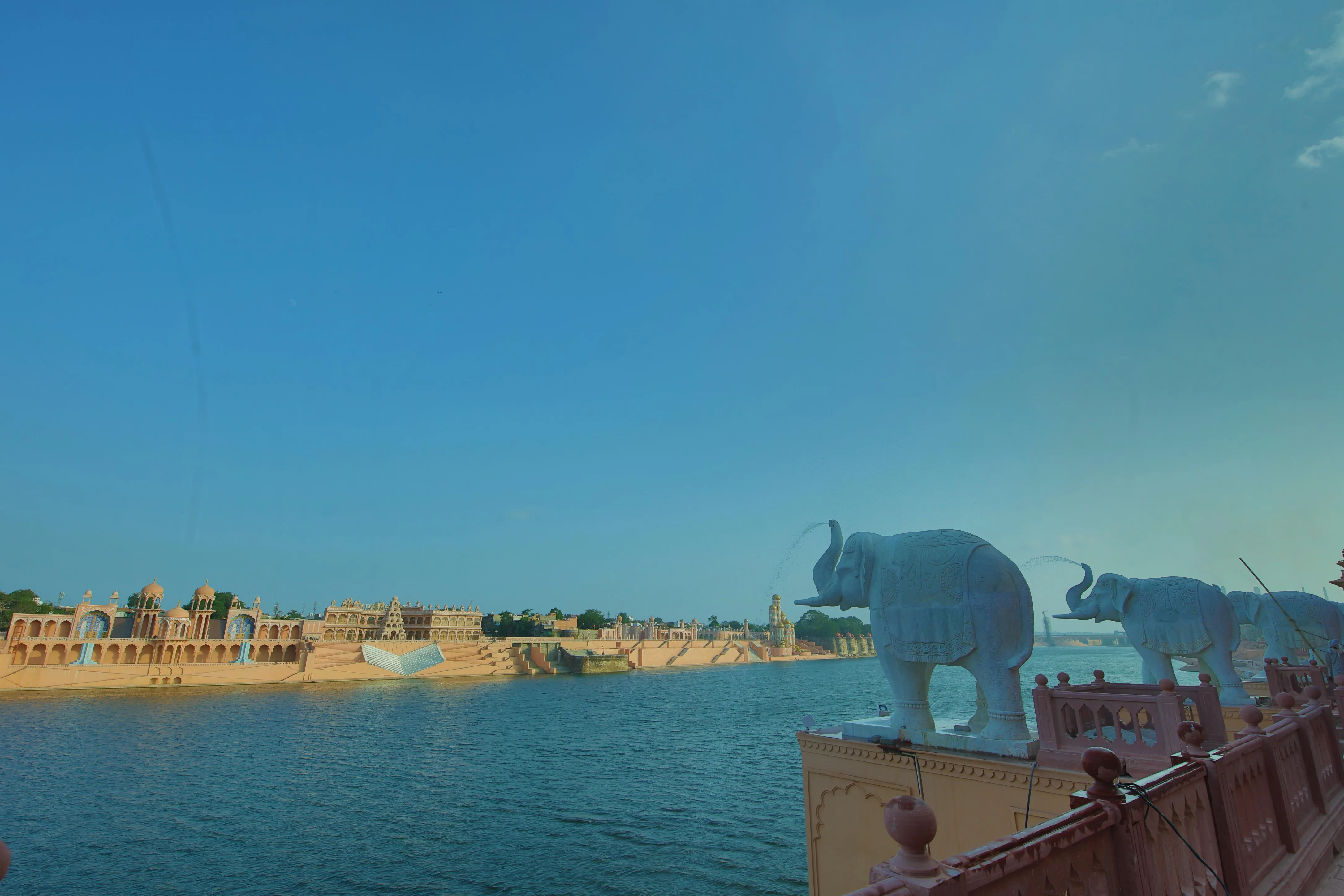 Stone elephant sculpture on a riverfront