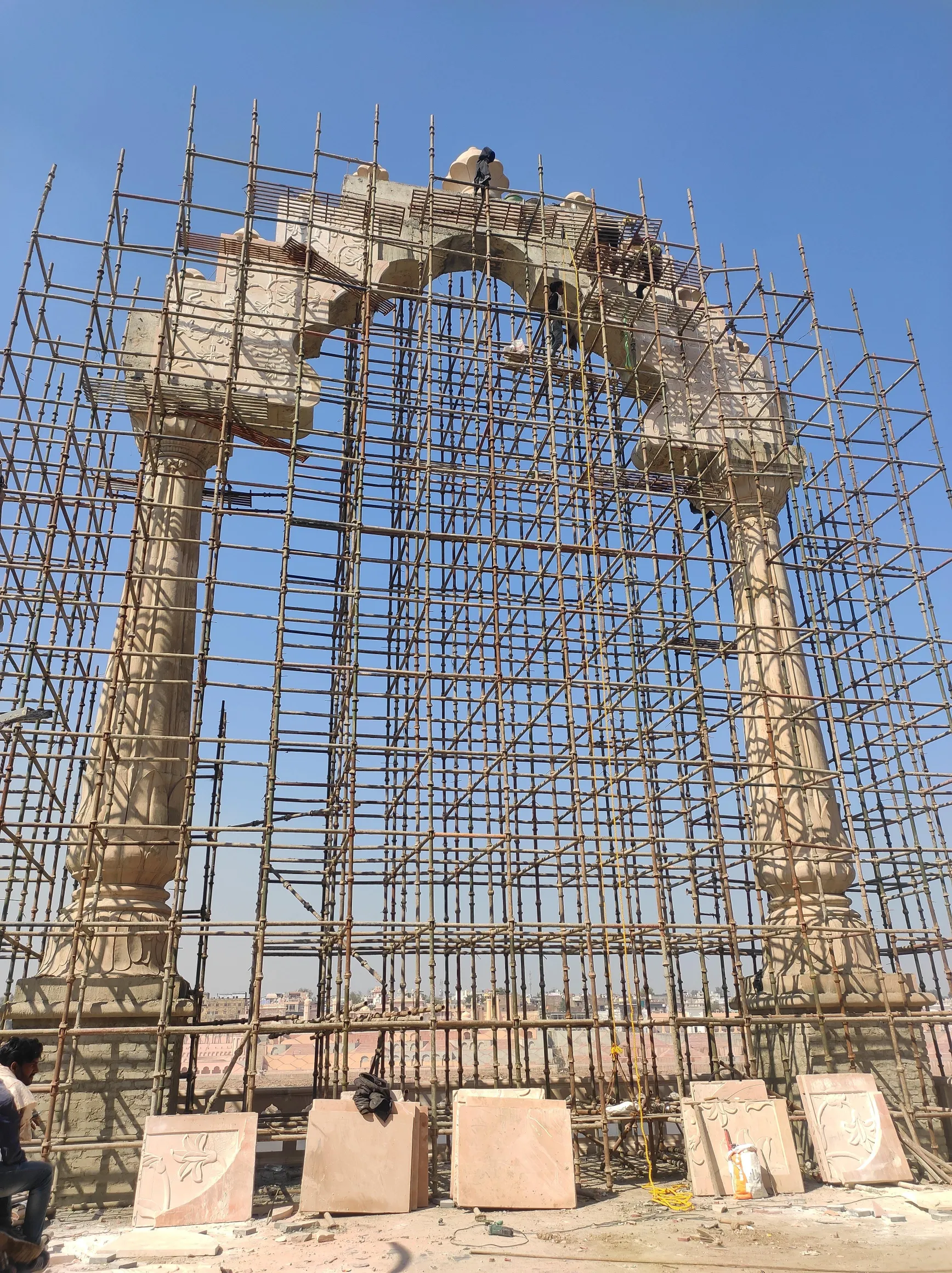 Carved stone arch rising on scaffolding – Grand Arch, Kota