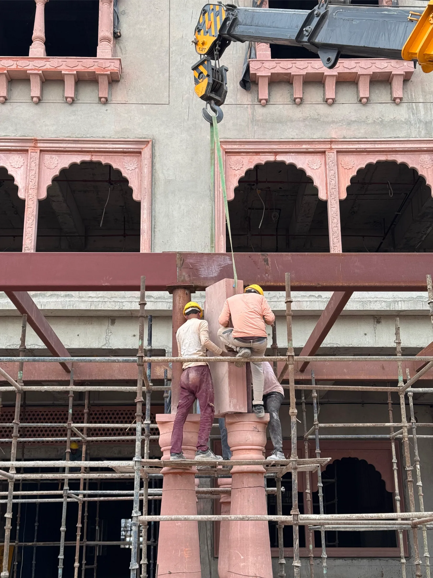 Workers installing carved sandstone pillars – Jaipur Junction Redevelopment, Jaipur