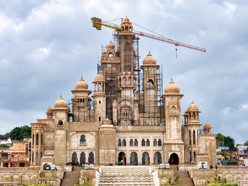 Stone installation crew and crane at an active site