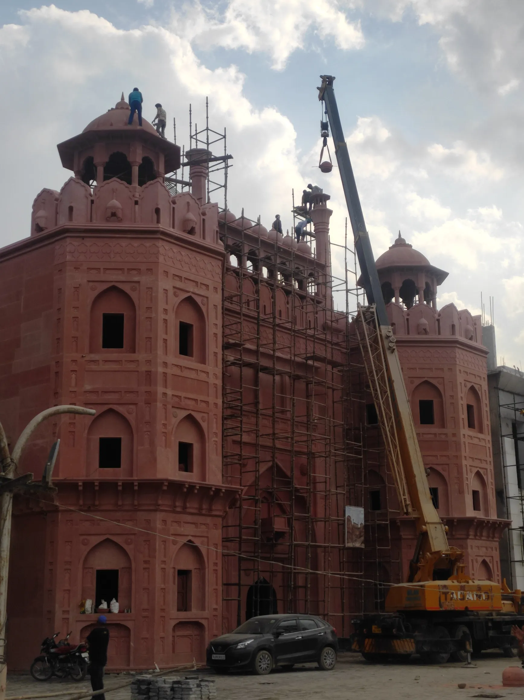 Red sandstone fort façade with crane – Red Fort, Kota
