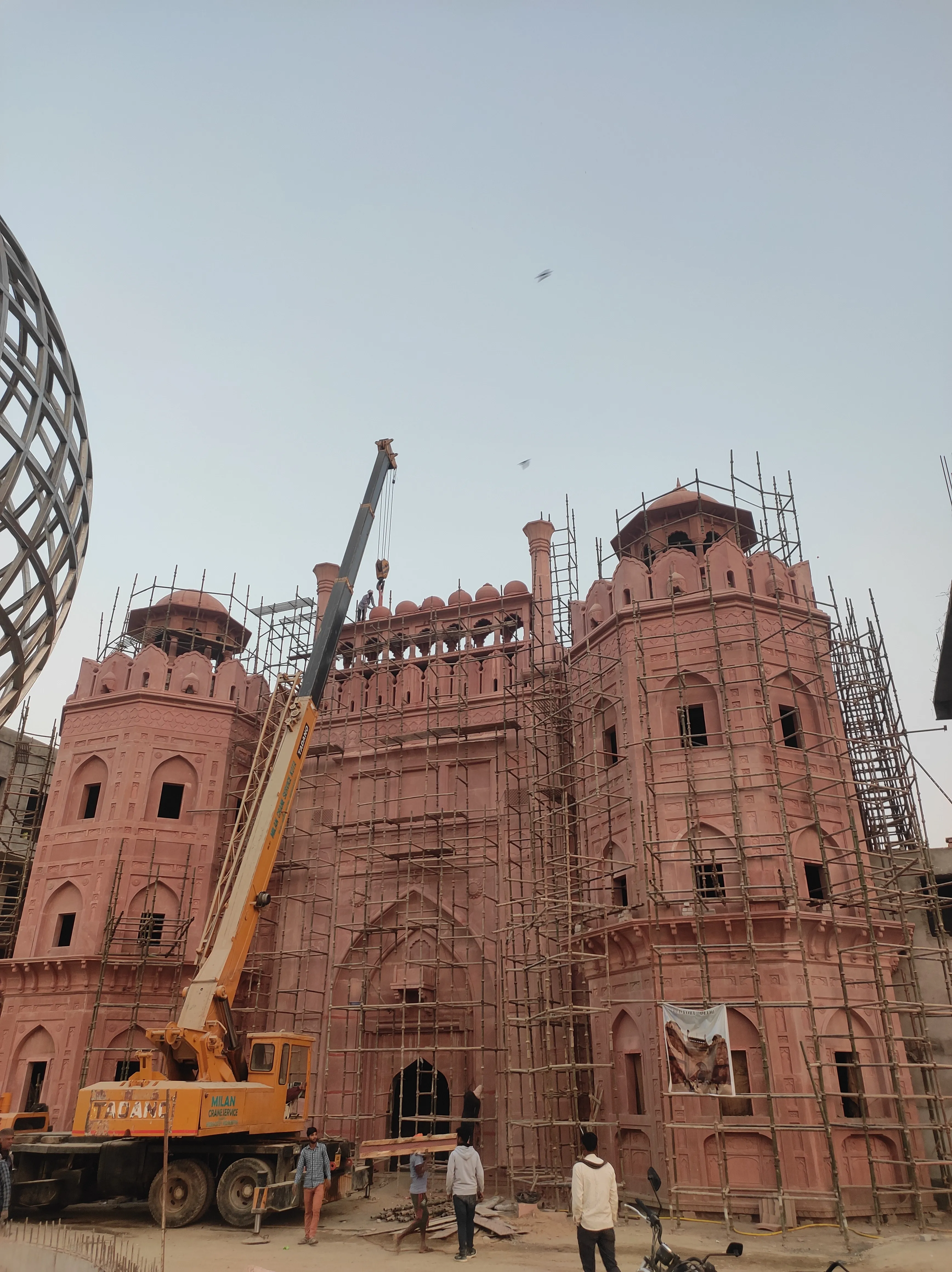 Fort façade with crane during construction – Red Fort, Kota