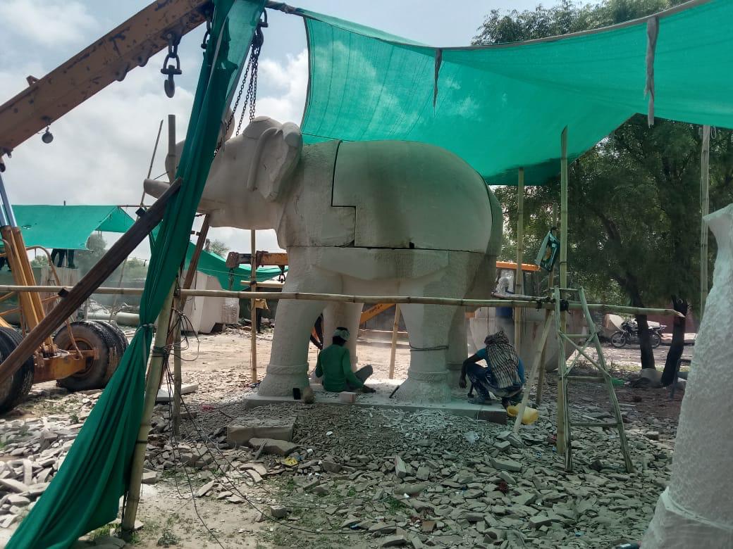 Stone elephant sculpture taking shape under a shade net – Kota Riverfront, Kota