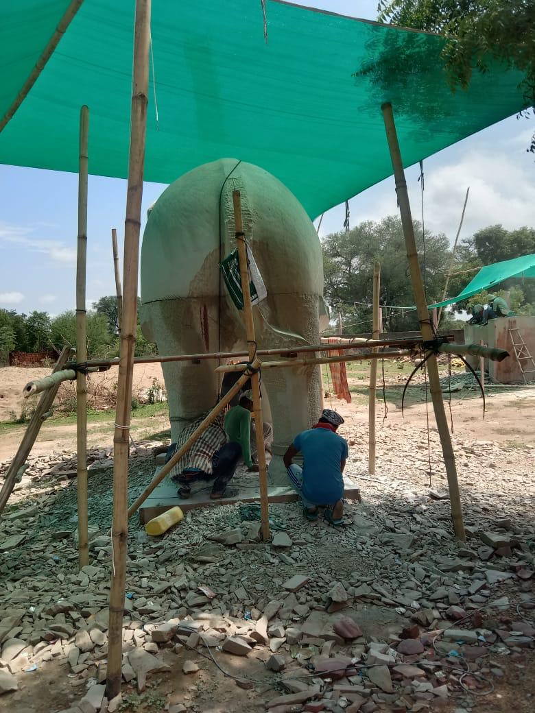 Artisans carving a stone elephant under a shade net – Kota Riverfront, Kota