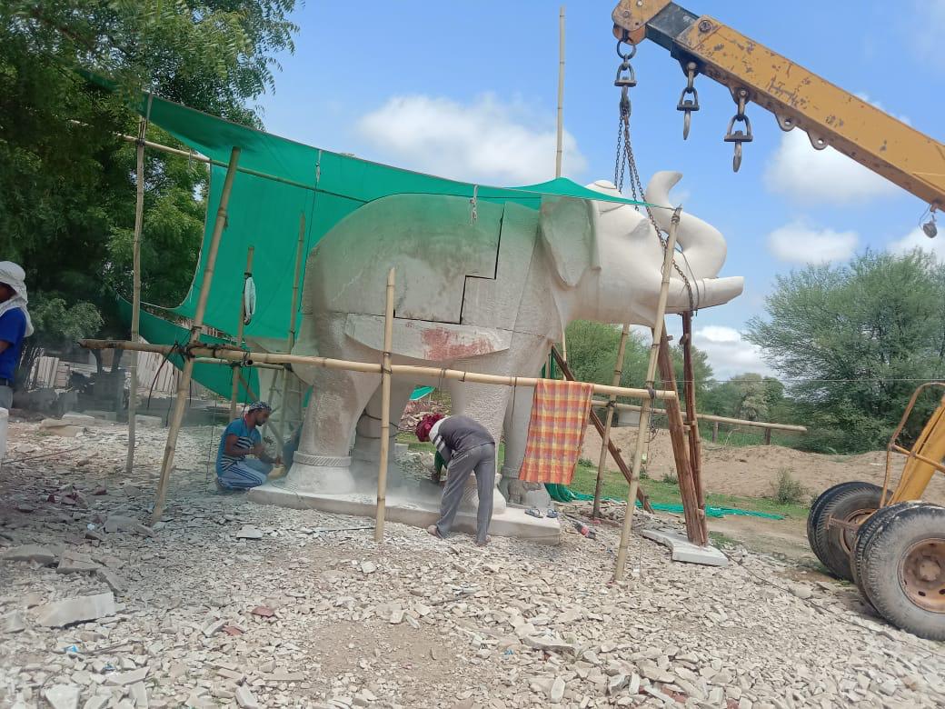 Craftsmen hand-carving a large stone elephant on site – Kota Riverfront, Kota