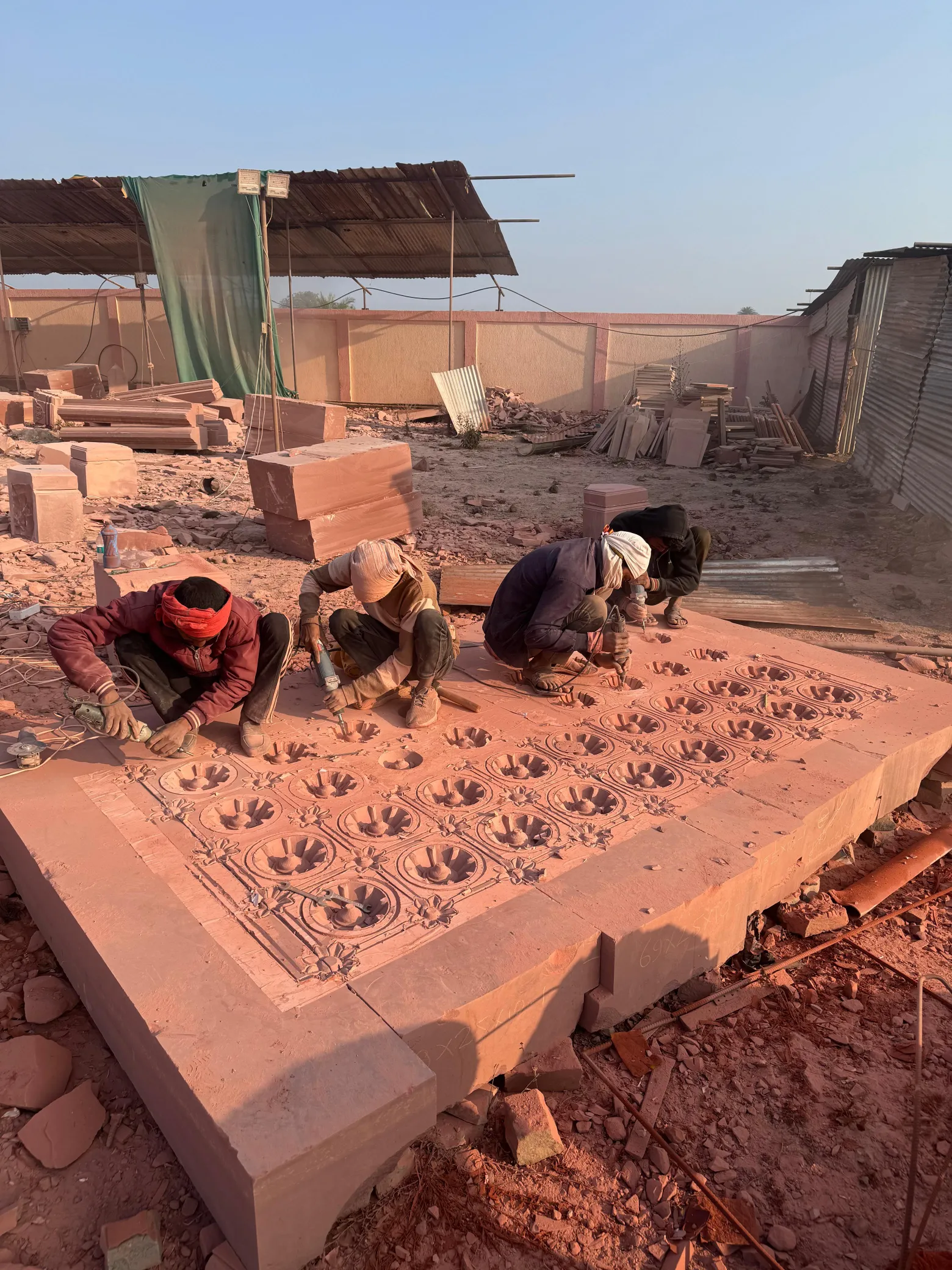 Artisans carving a sandstone ceiling panel – Sant Ravidas Temple, Sagar