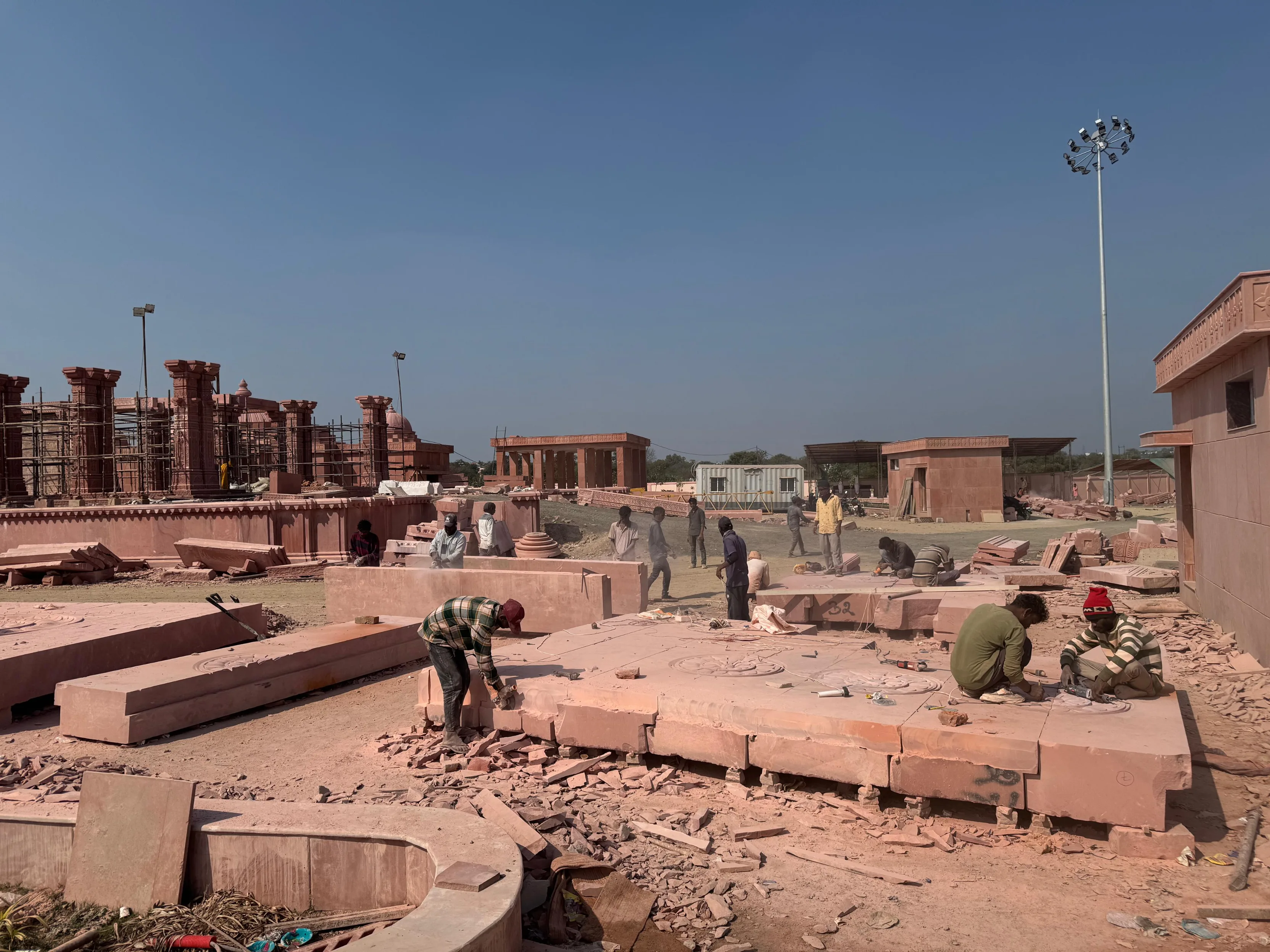 Artisans carving red sandstone at the temple site – Sant Ravidas Temple, Sagar