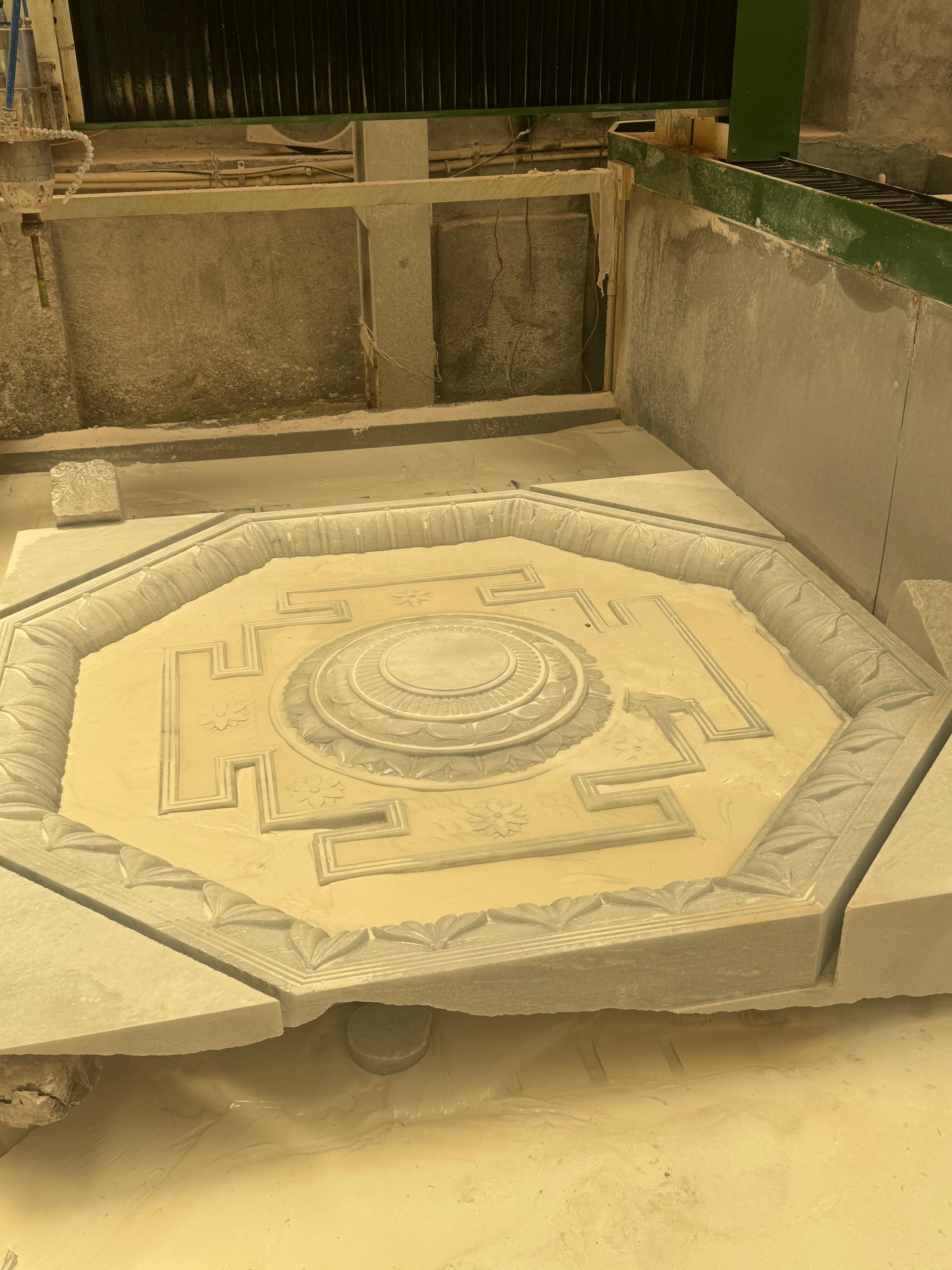 CNC-carved octagonal geometric pattern in a stone slab