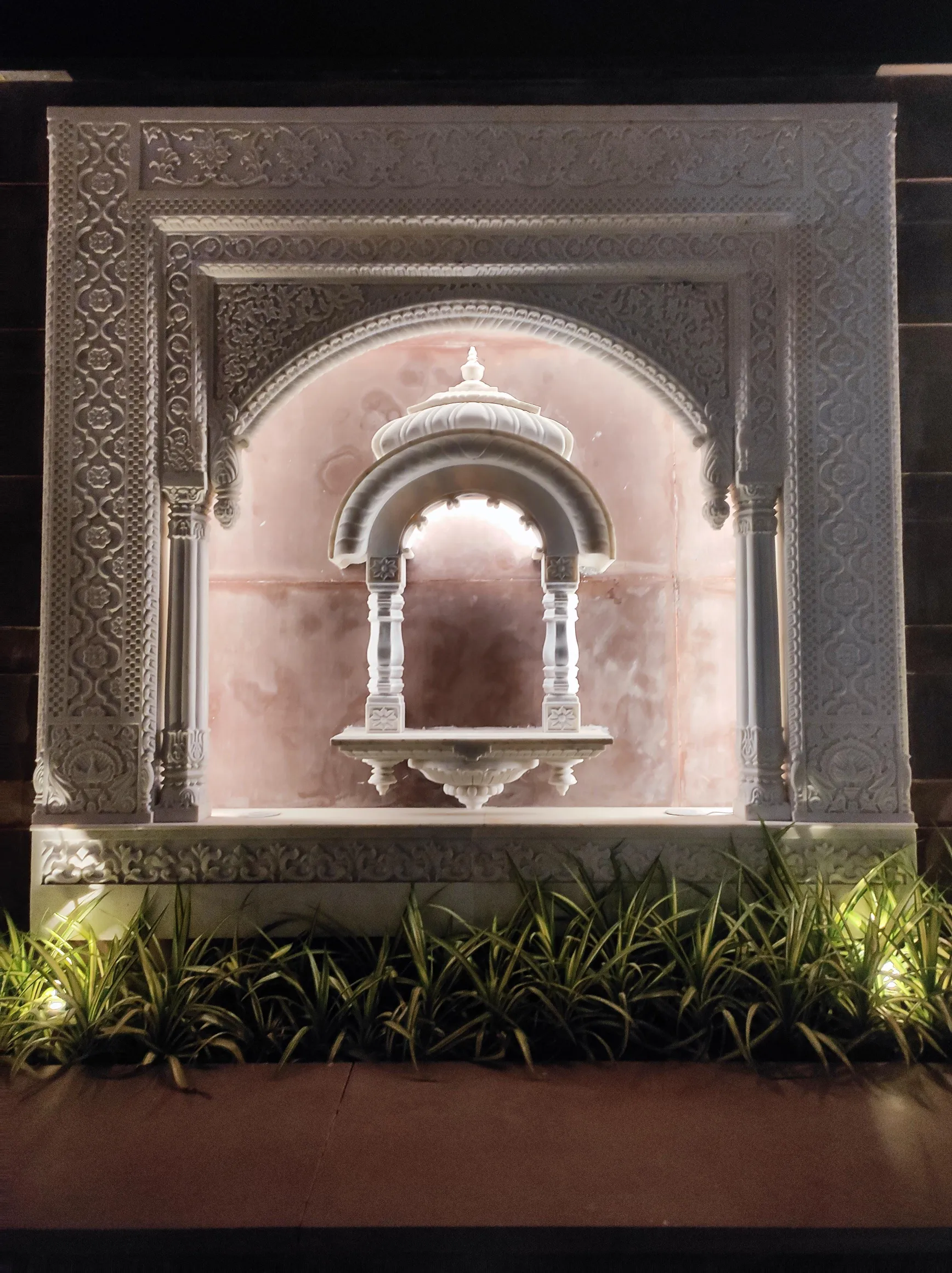 Carved stone jharokha window surround with mouldings and brackets