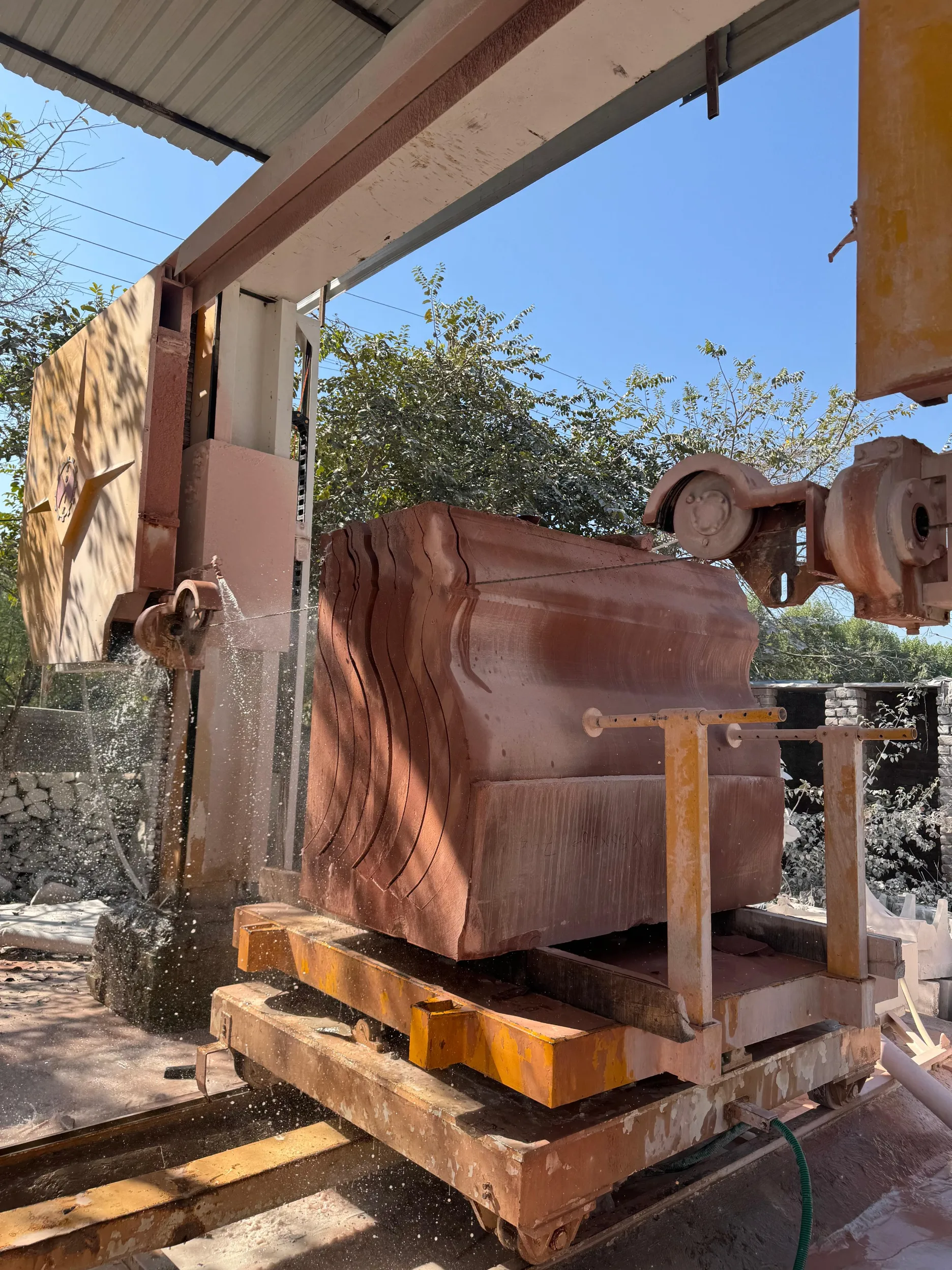 Stone block sliced into curved slabs by CNC wire saw