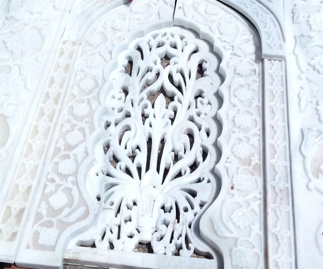 White marble jali screen carved in a traditional pattern