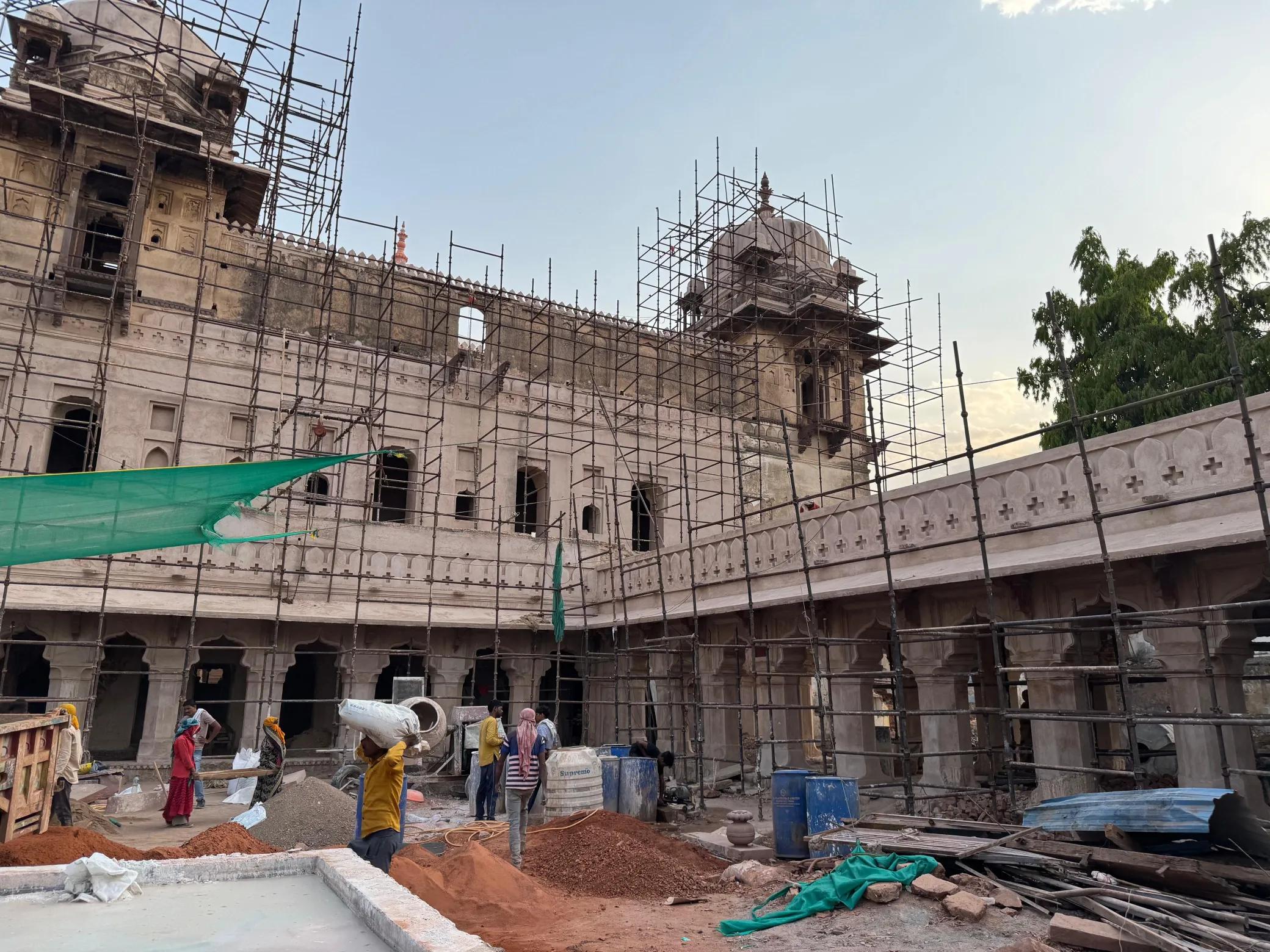 Historic palace under heritage stone restoration, wrapped in scaffolding