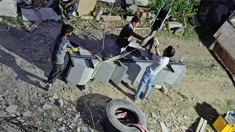 Team handling custom-cut stone components for shipment